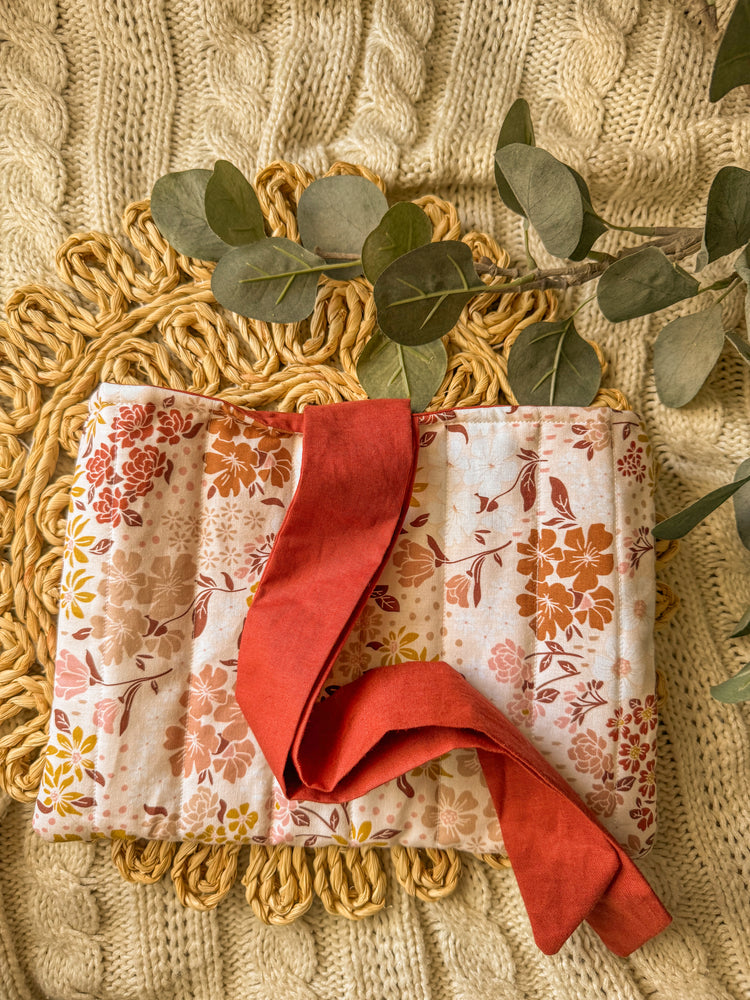 Floral quilted bow book sleeve with red bow tie closure