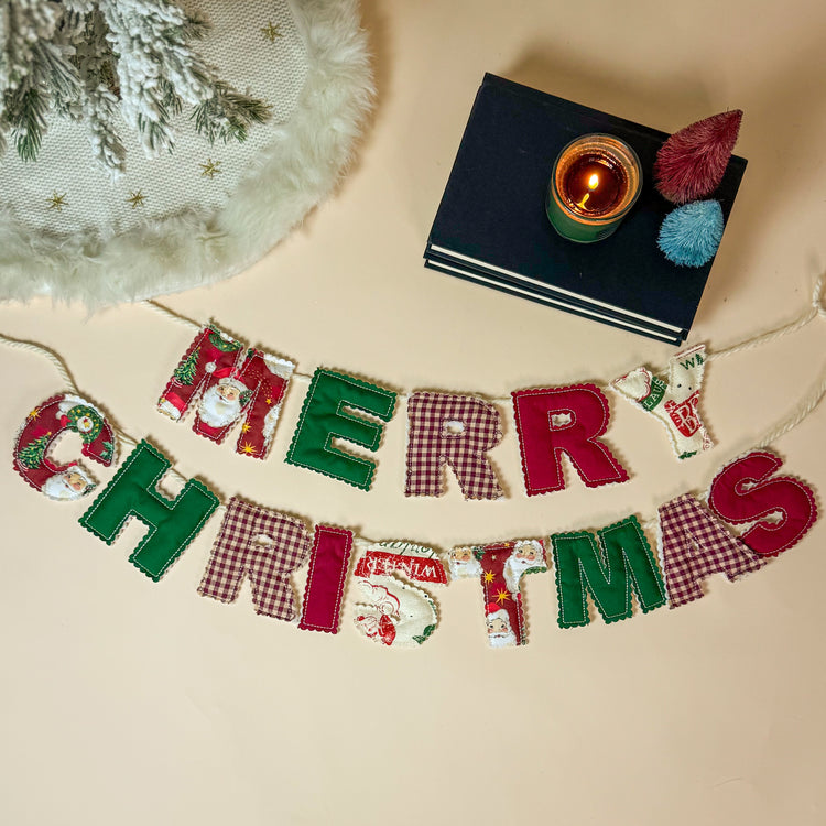 Merry Christmas banner with a candle and decorative items on a beige background
