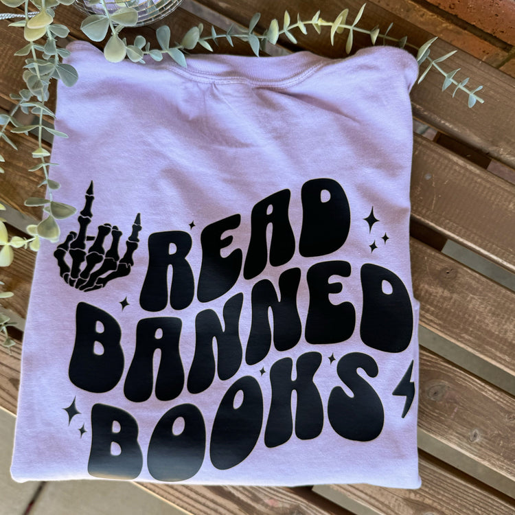 Close-up of Read Banned Books graphic tee showing front pocket and soft cotton texture.