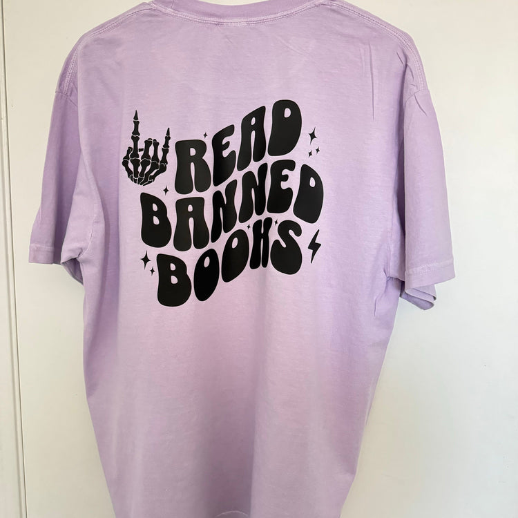 Lavender bookish shirt with playful typography and cozy styling.