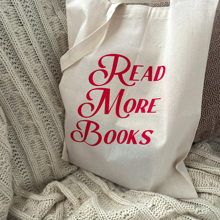 Beige canvas tote bag with Read More Books text in red vintage typography