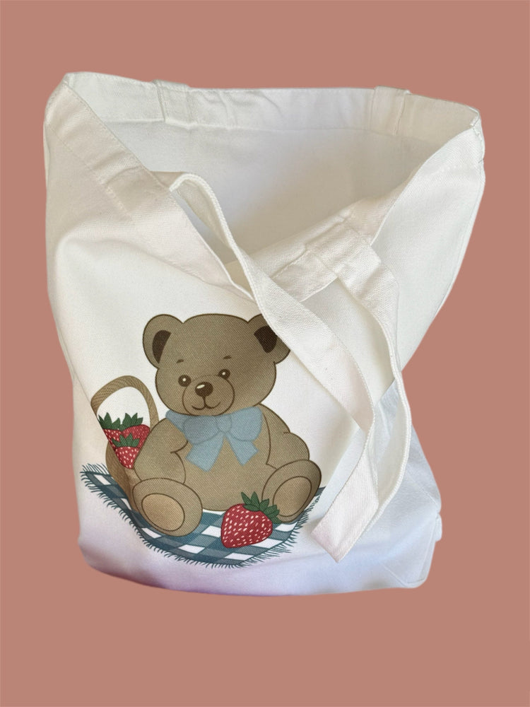 Canvas tote bag with teddy bears, strawberries, and books in coquette pastel colors