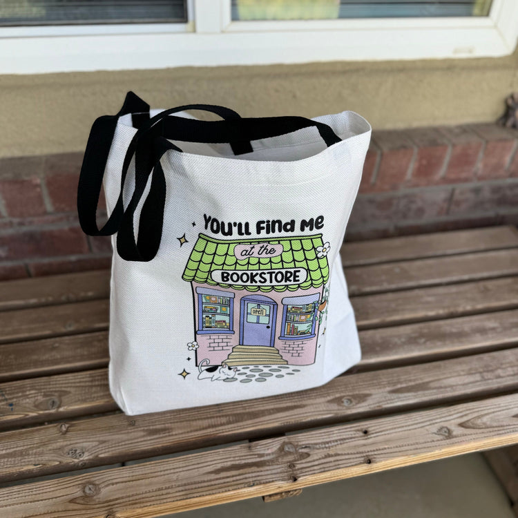 Bookstore tote bag showing vibrant book spine design and quote detail
