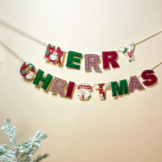 Full view of the Merry Christmas garland with warm holiday decorations.