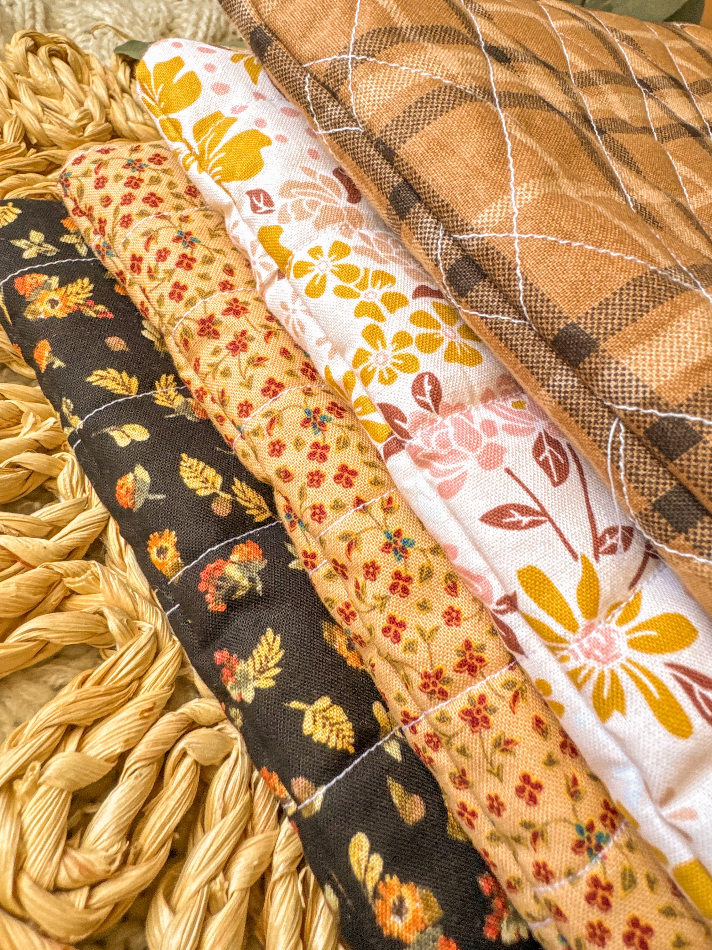 Collection of fabric strips with autumnal patterns on a textured surface