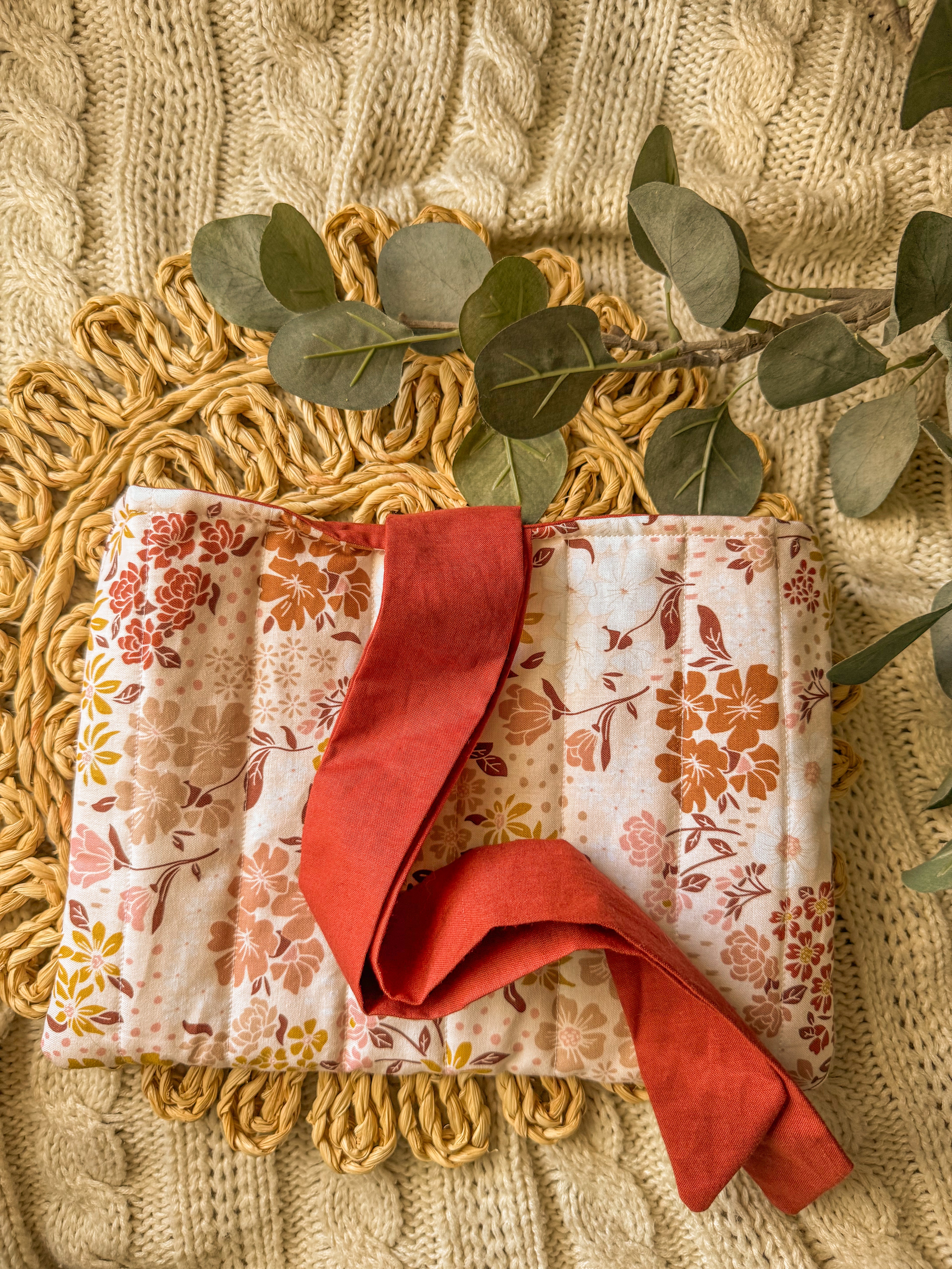 Floral quilted bow book sleeve with red bow tie closure