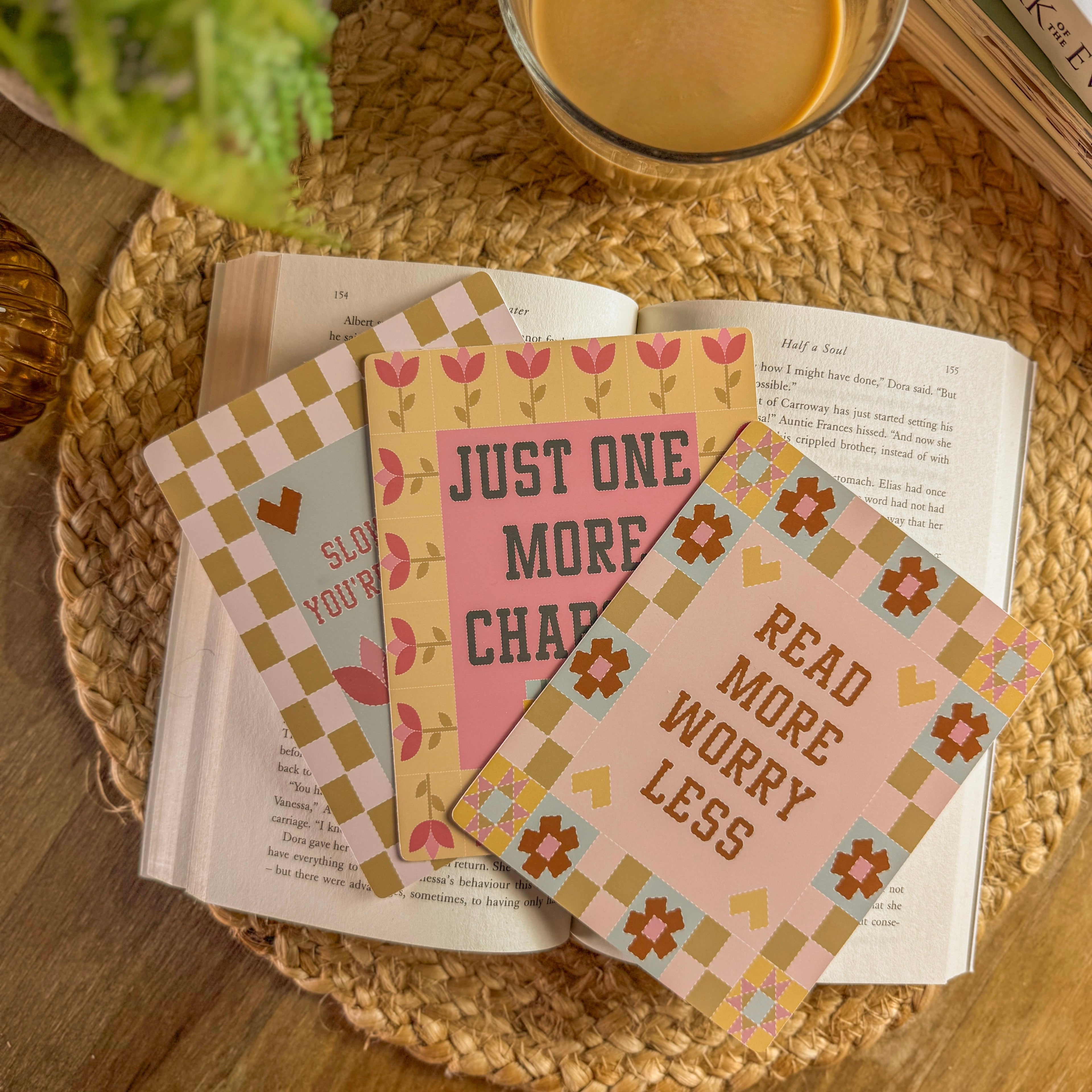 Stack of motivational e reader inserts on a table with a cup of coffee