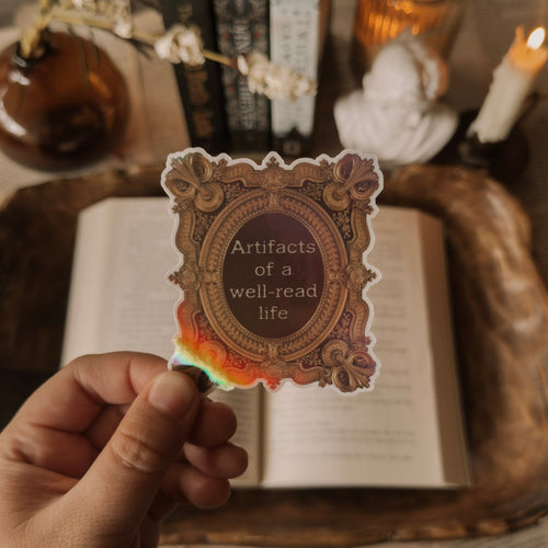 Dark Academia aesthetic sticker for Kindle, featuring a holographic ornate frame and bookish quote.