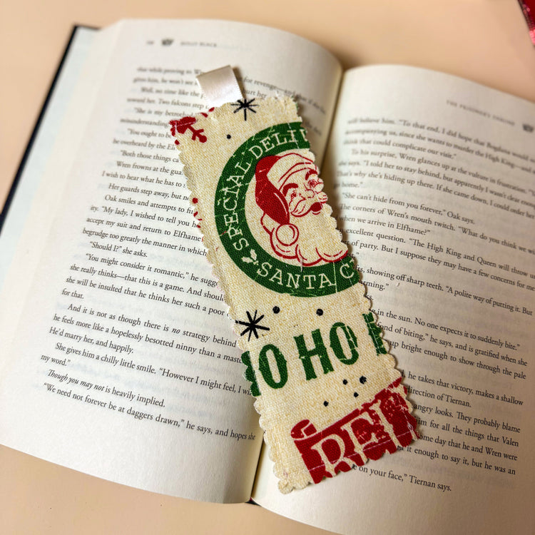 Decorative bookmark with Santa Claus design on an open book