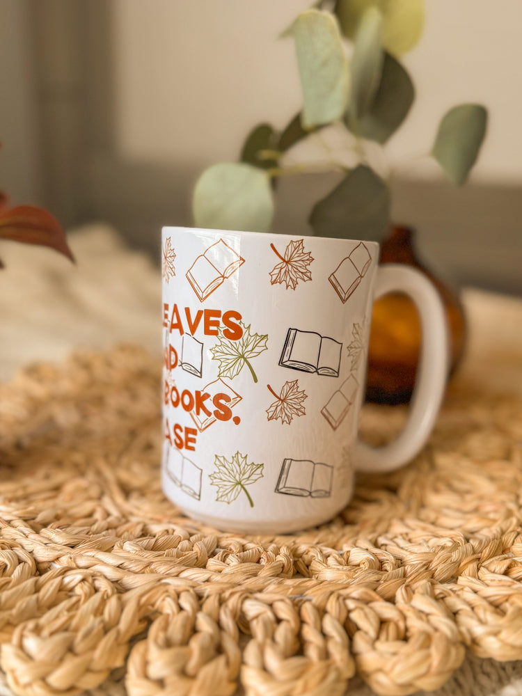 White mug with text and icons on a woven mat with plants in the background