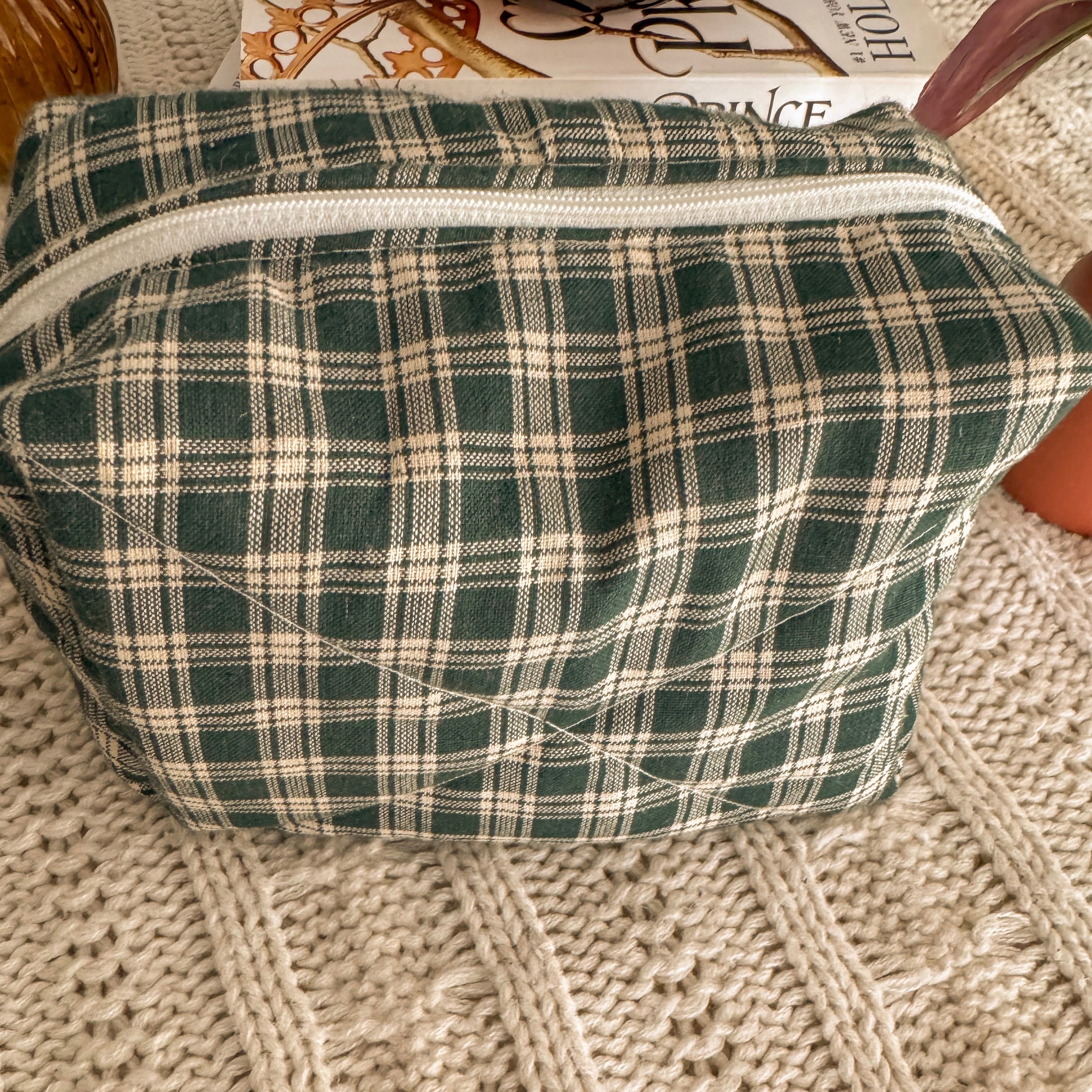 Close up of quilted green plaid zipper pouch