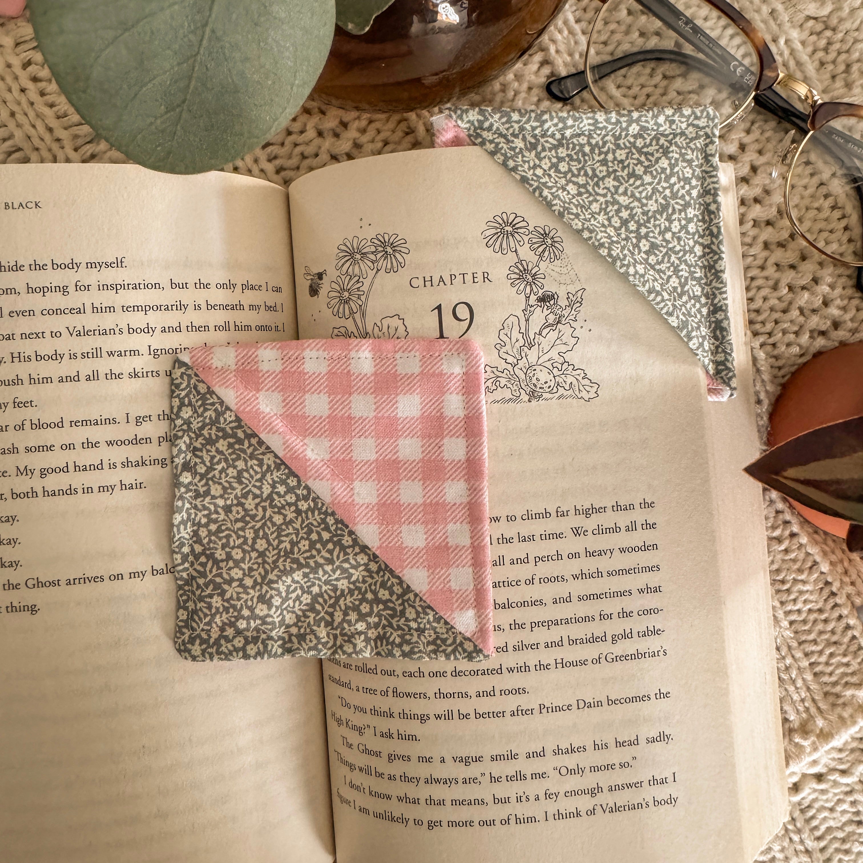 Set of 2 Green and Pink Floral Bookmarks in use, holding a page in a book.