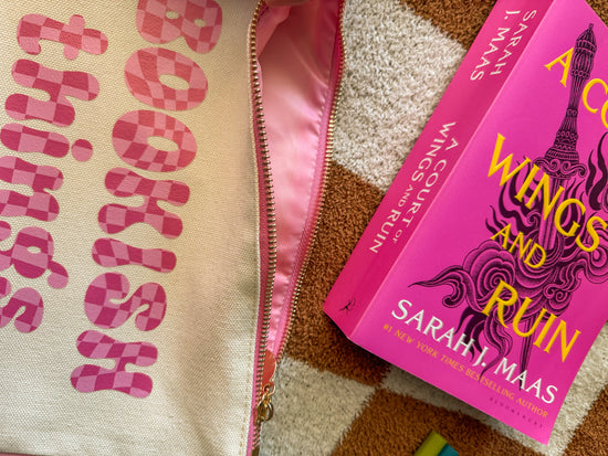 Close-up of pink bubble font on pouch reading “Bookish Things”