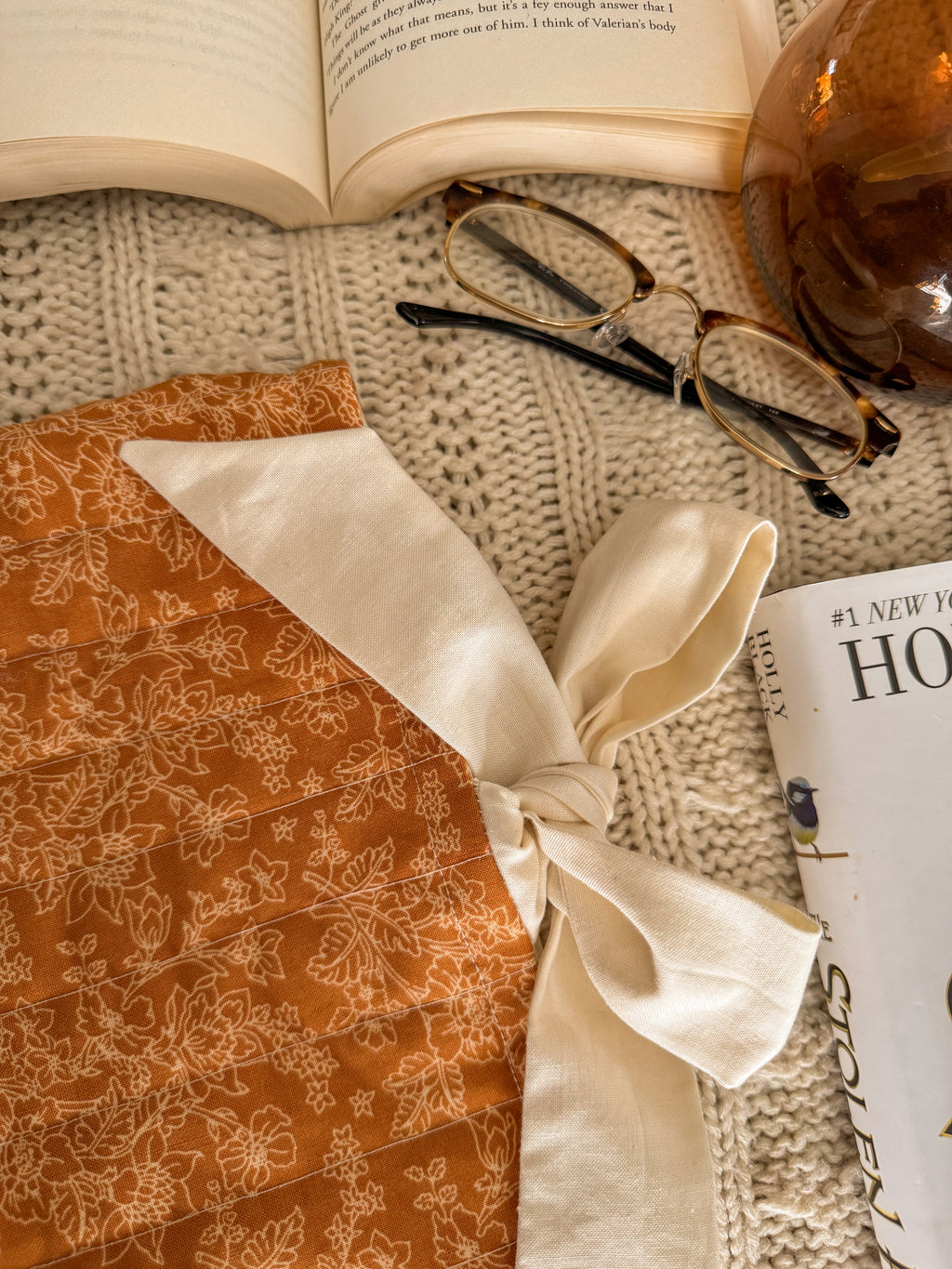 Close-up of autumn floral book pouch with book peeking out

