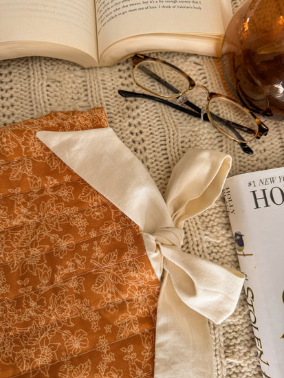 Close-up of autumn floral book pouch with book peeking out


