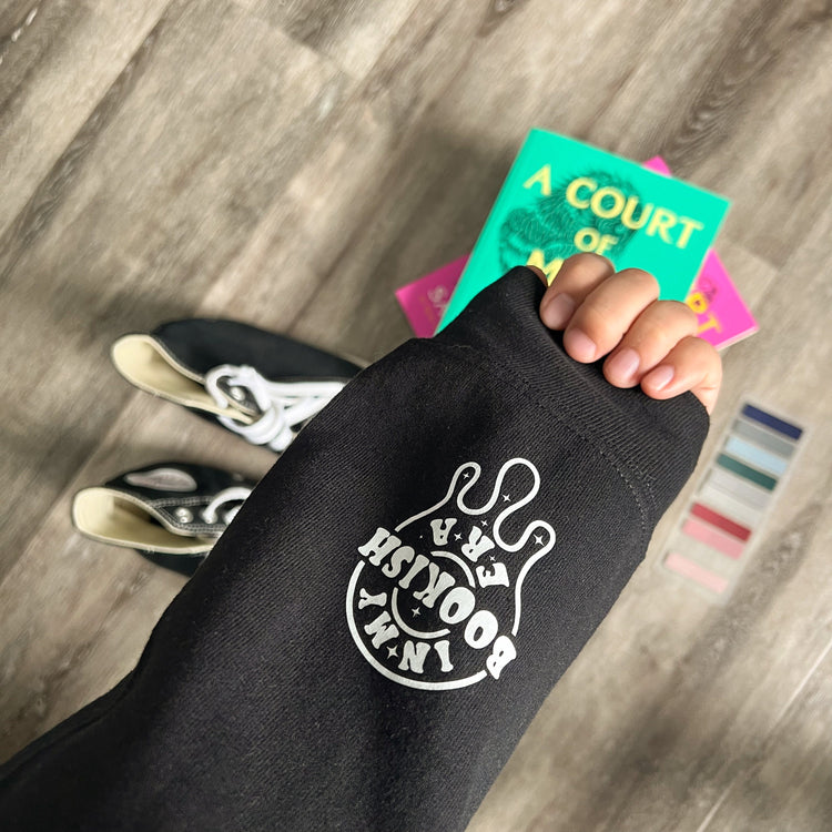 Close-up of hoodie fabric showing skeleton design on sleeves.