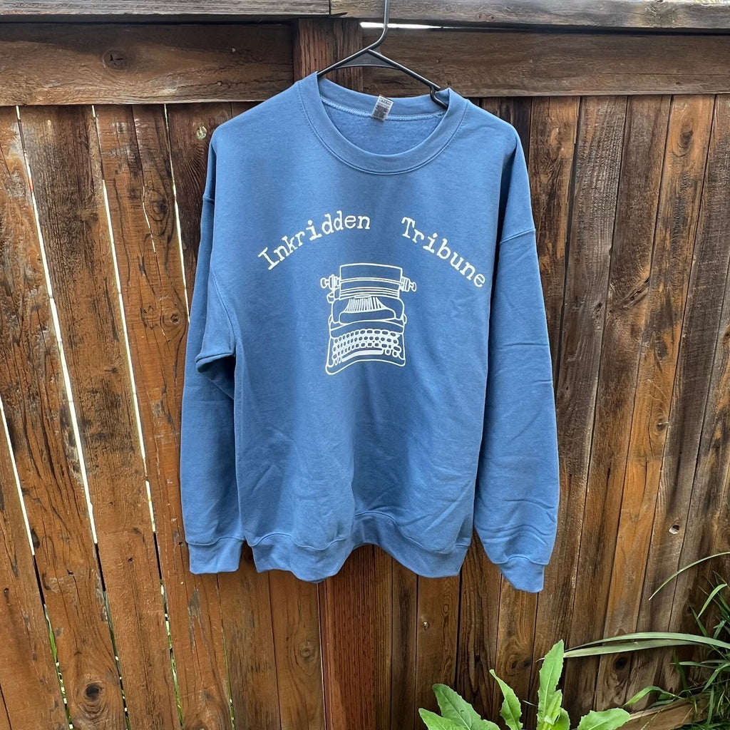 Blue Divine Rivals sweatshirt with Inkridden Tribune-inspired bookish quote, styled with books and cozy reading props.