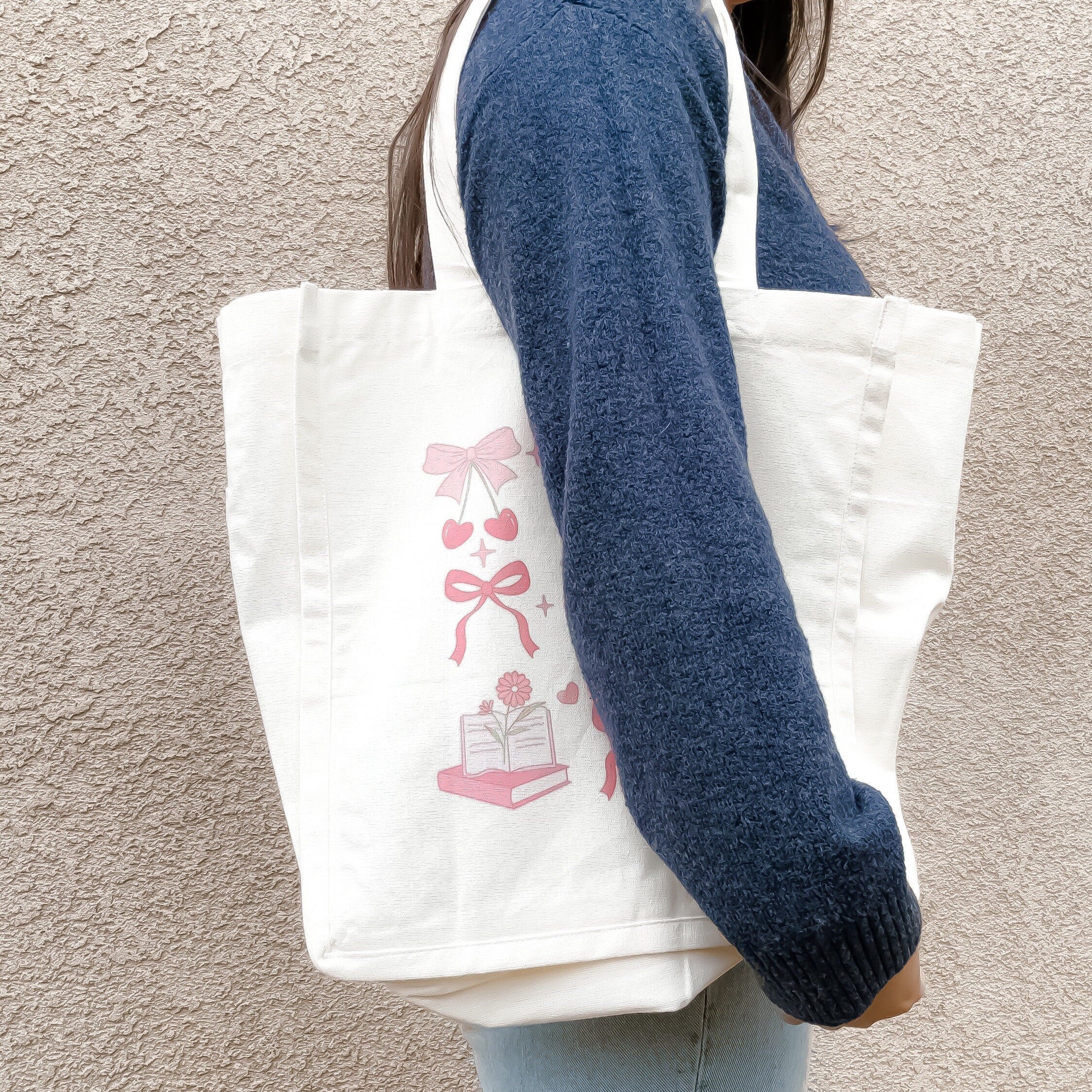 Pink coquette library tote bag with books, bows, and cherries pattern