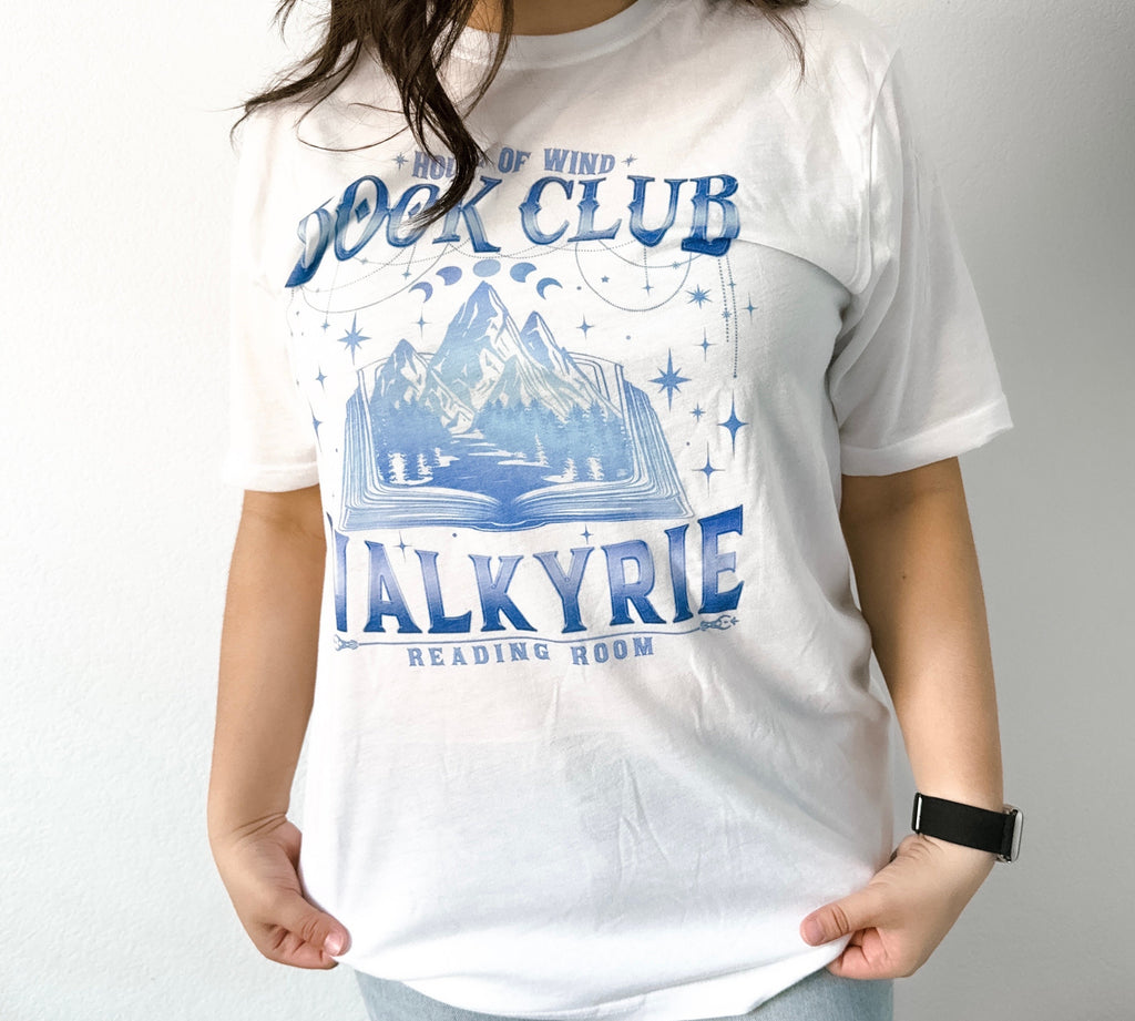 White ACOTAR Valkyrie Book Club tee with House of Wind graphic, styled with books and cozy accents.