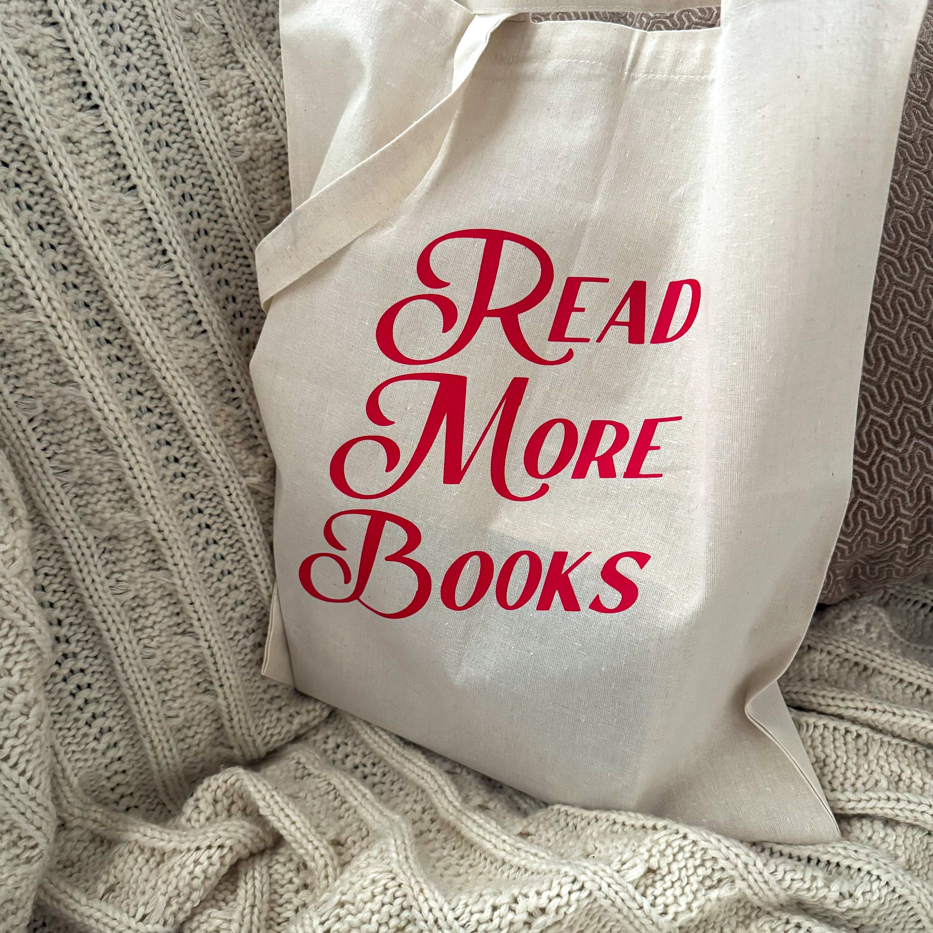 Beige canvas tote bag with Read More Books text in red vintage typography