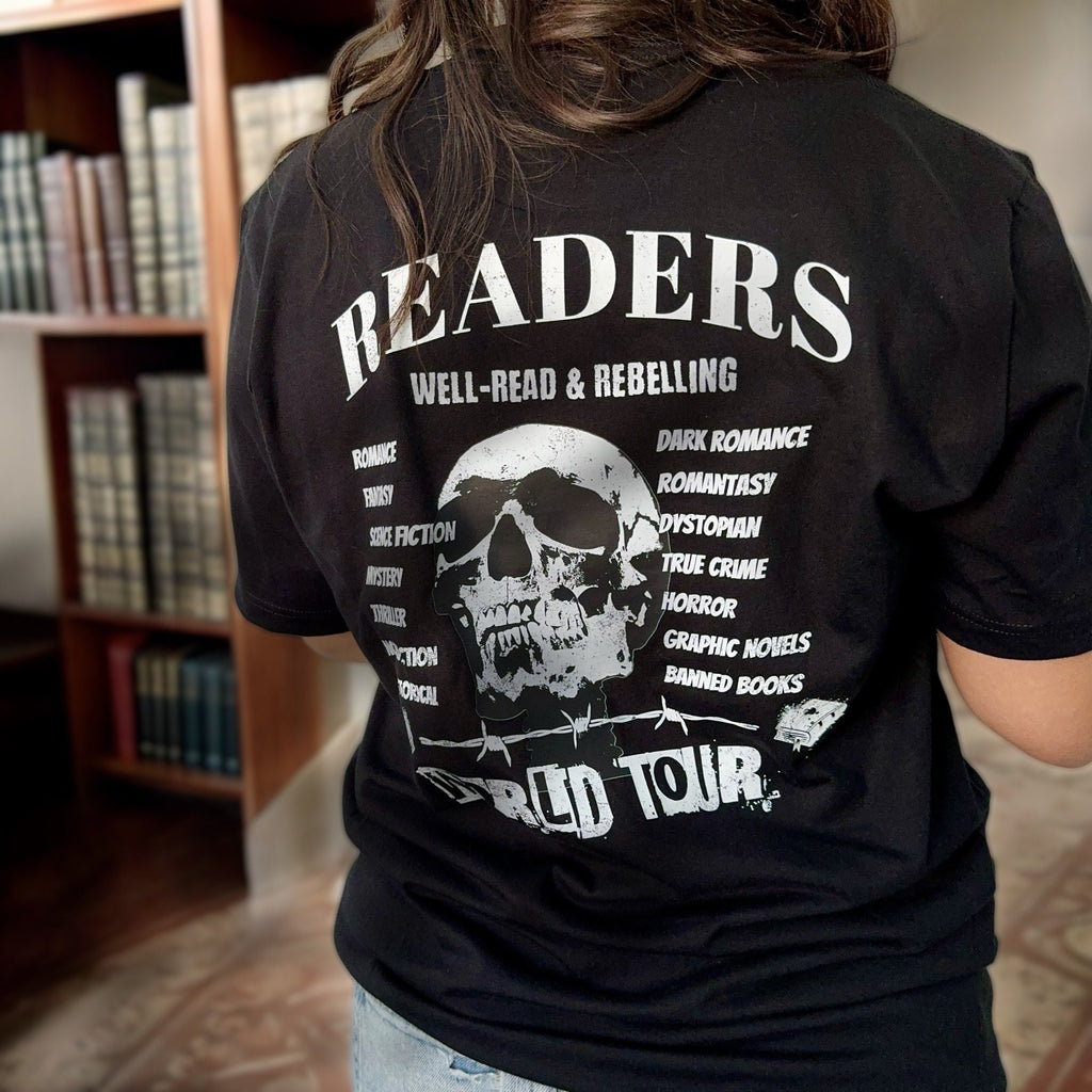 Black Bookish World Tour tee with literary graphic, styled with books and cozy accents.