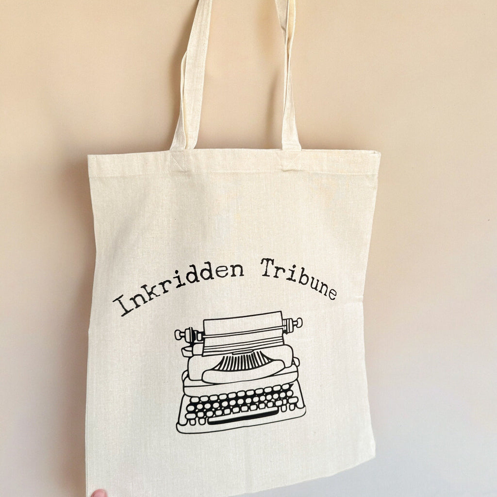 Canvas tote showing Divine Rivals newspaper typography detail