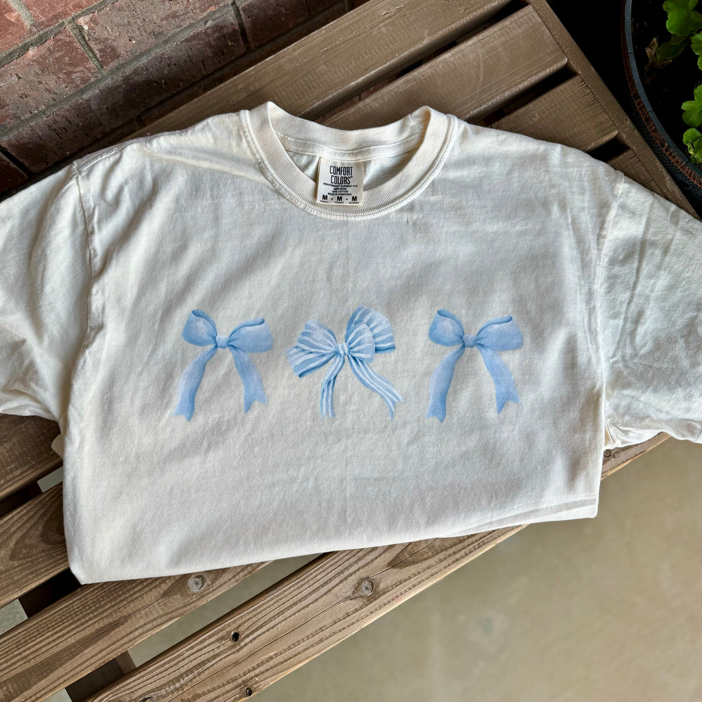 Flat lay of cropped tee styled for cozy reading afternoons.