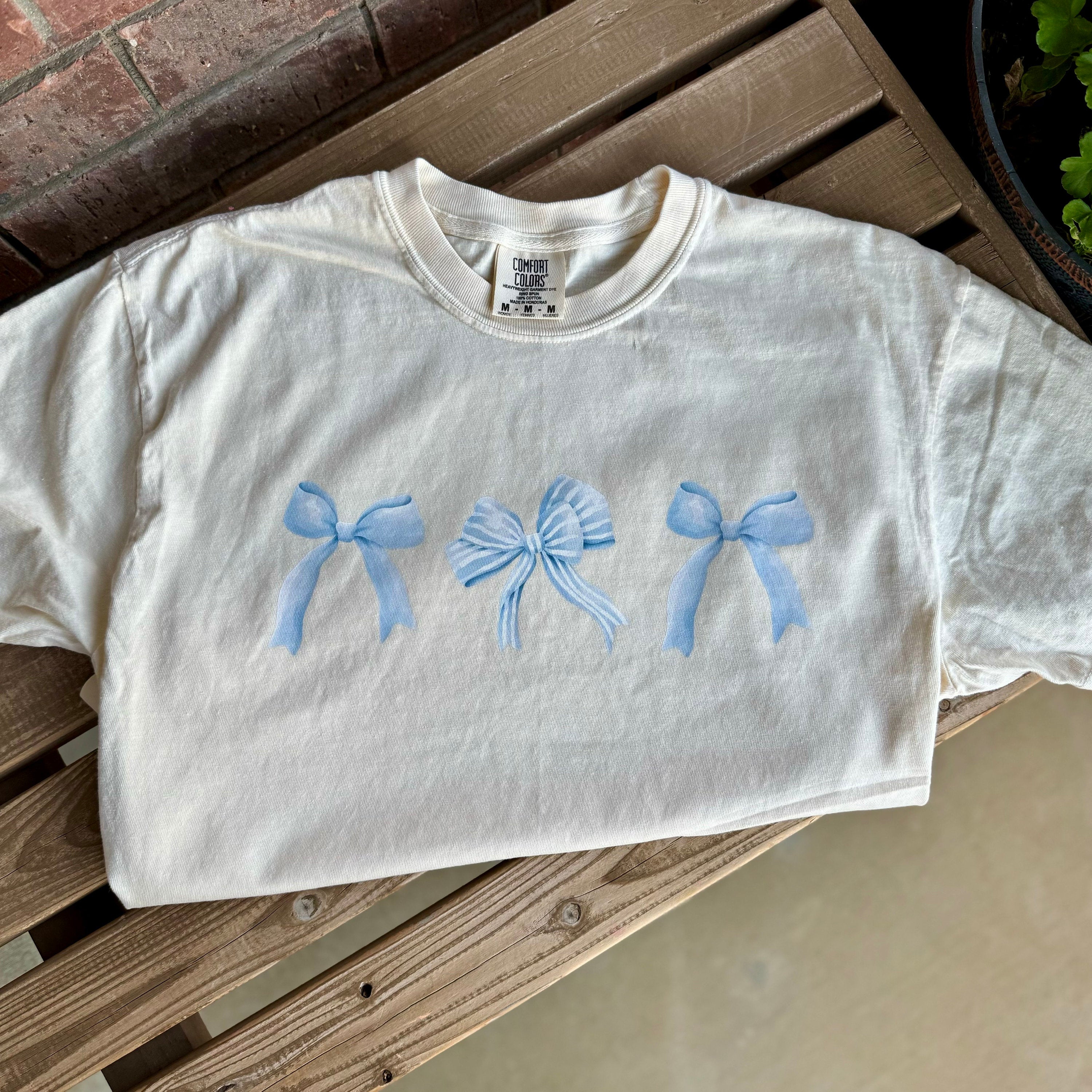 Flat lay of cropped tee styled for cozy reading afternoons.