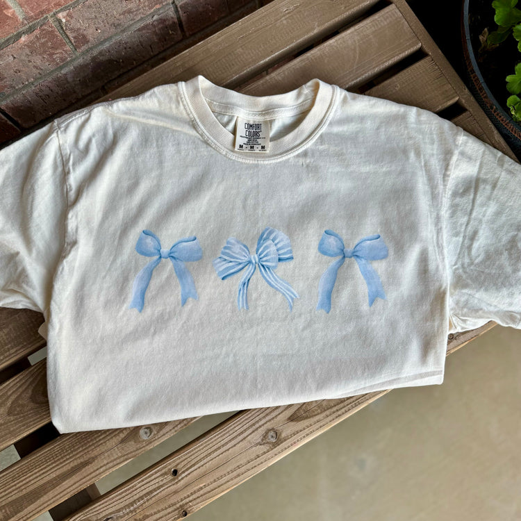 Flat lay of cropped tee styled for cozy reading afternoons.