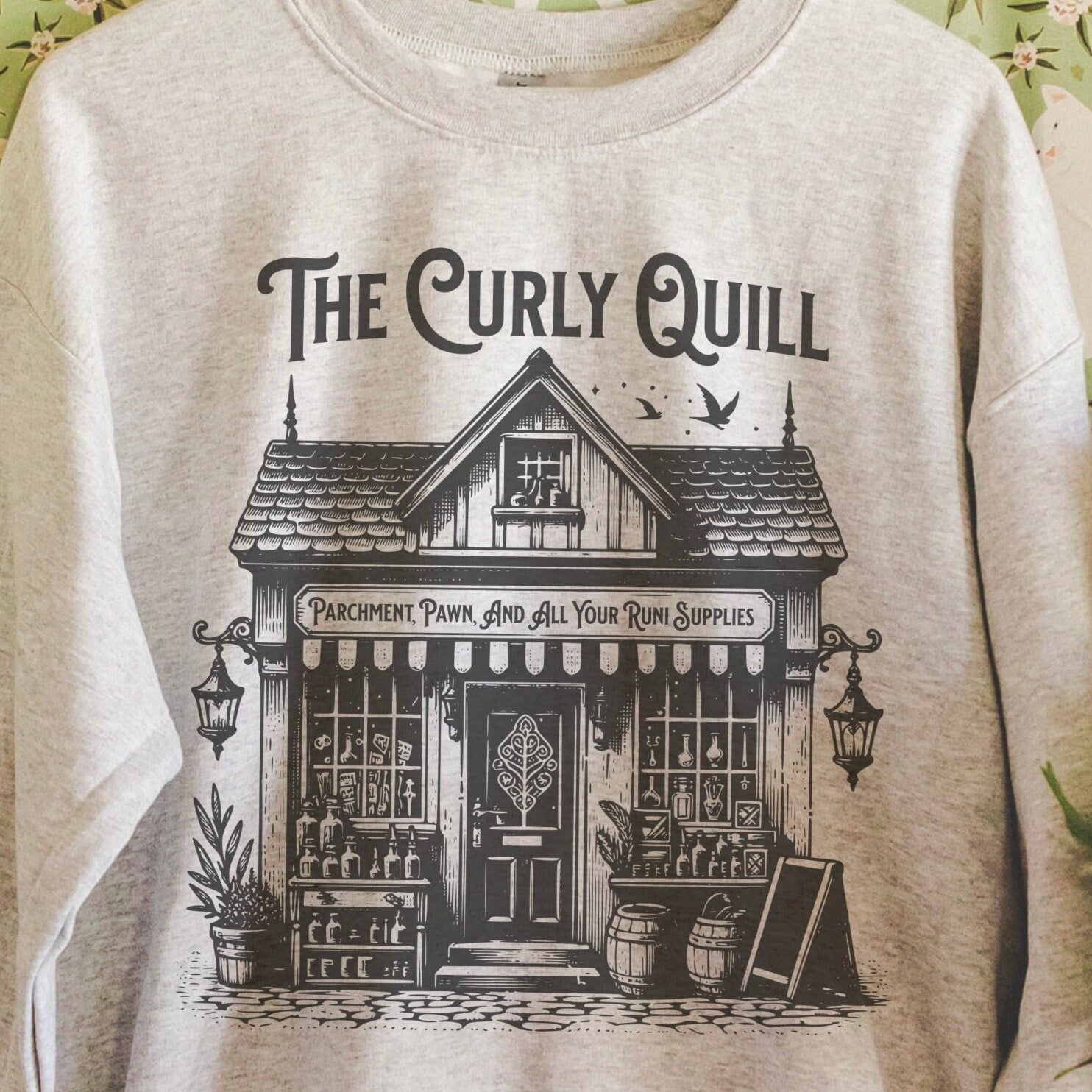 Close-up of soft sweatshirt showing faded graphic and cozy fabric texture.