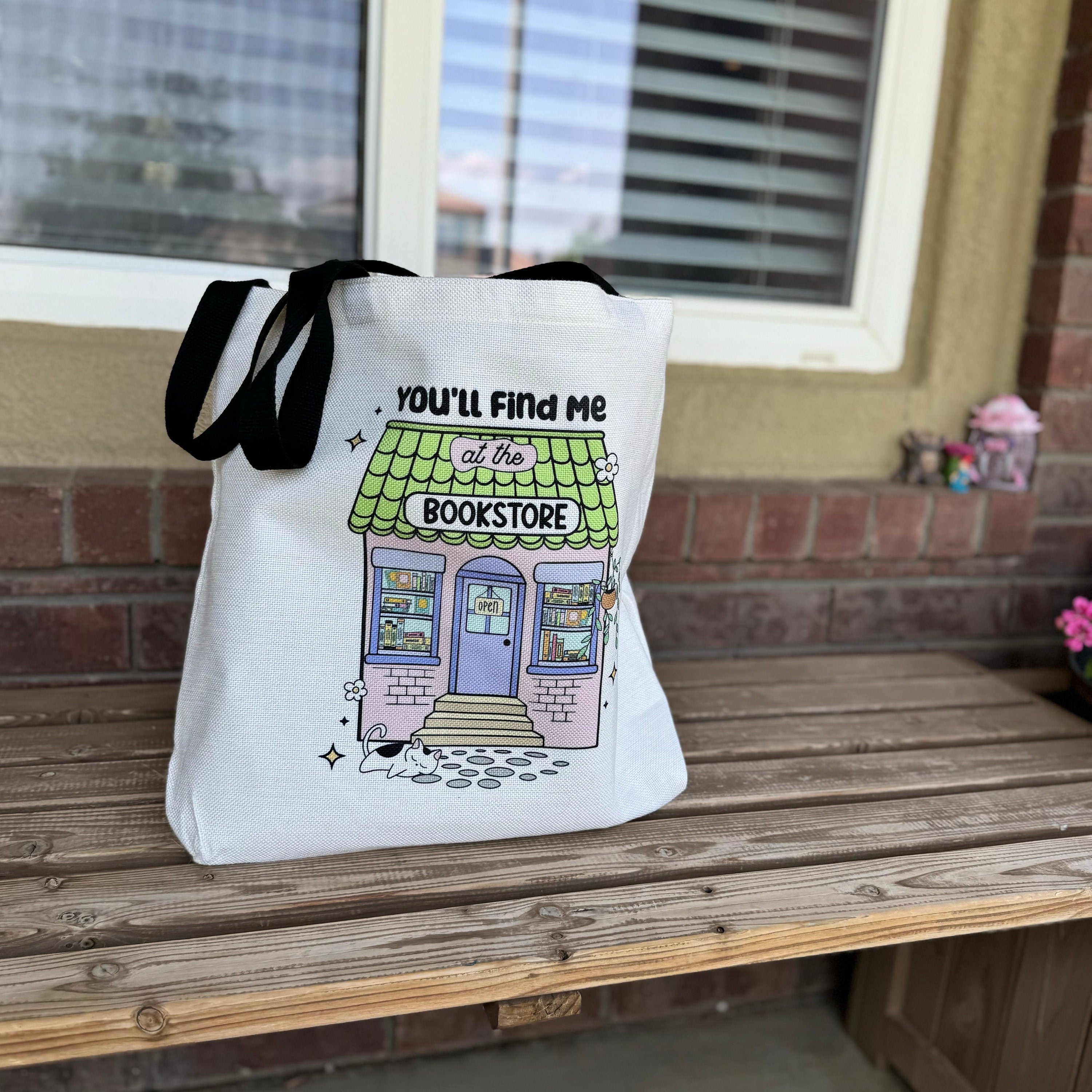 Canvas tote bag with colorful bookshelf illustration and You'll Find Me at the Bookstore text