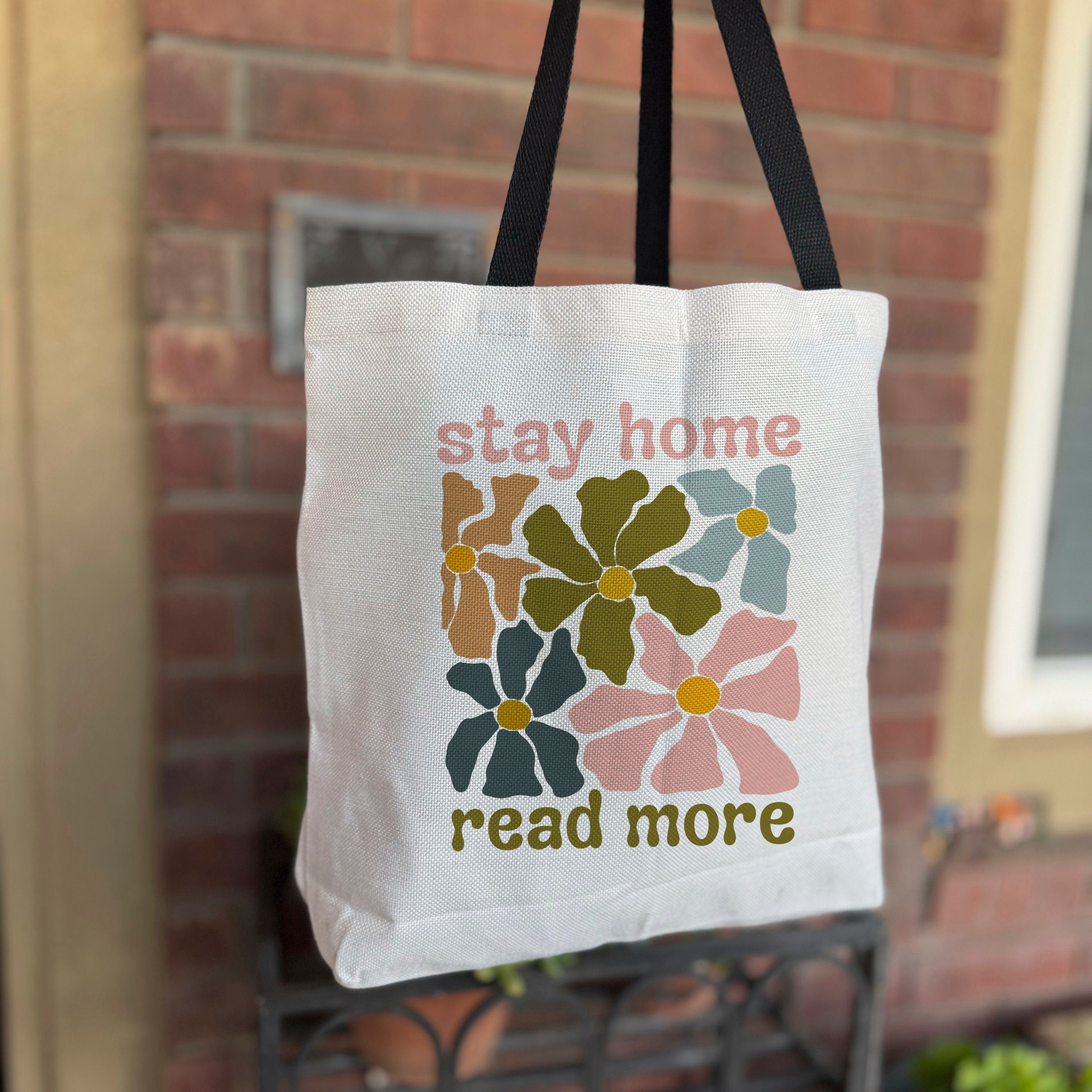 Book lover tote bag with colorful floral pattern and reading quote