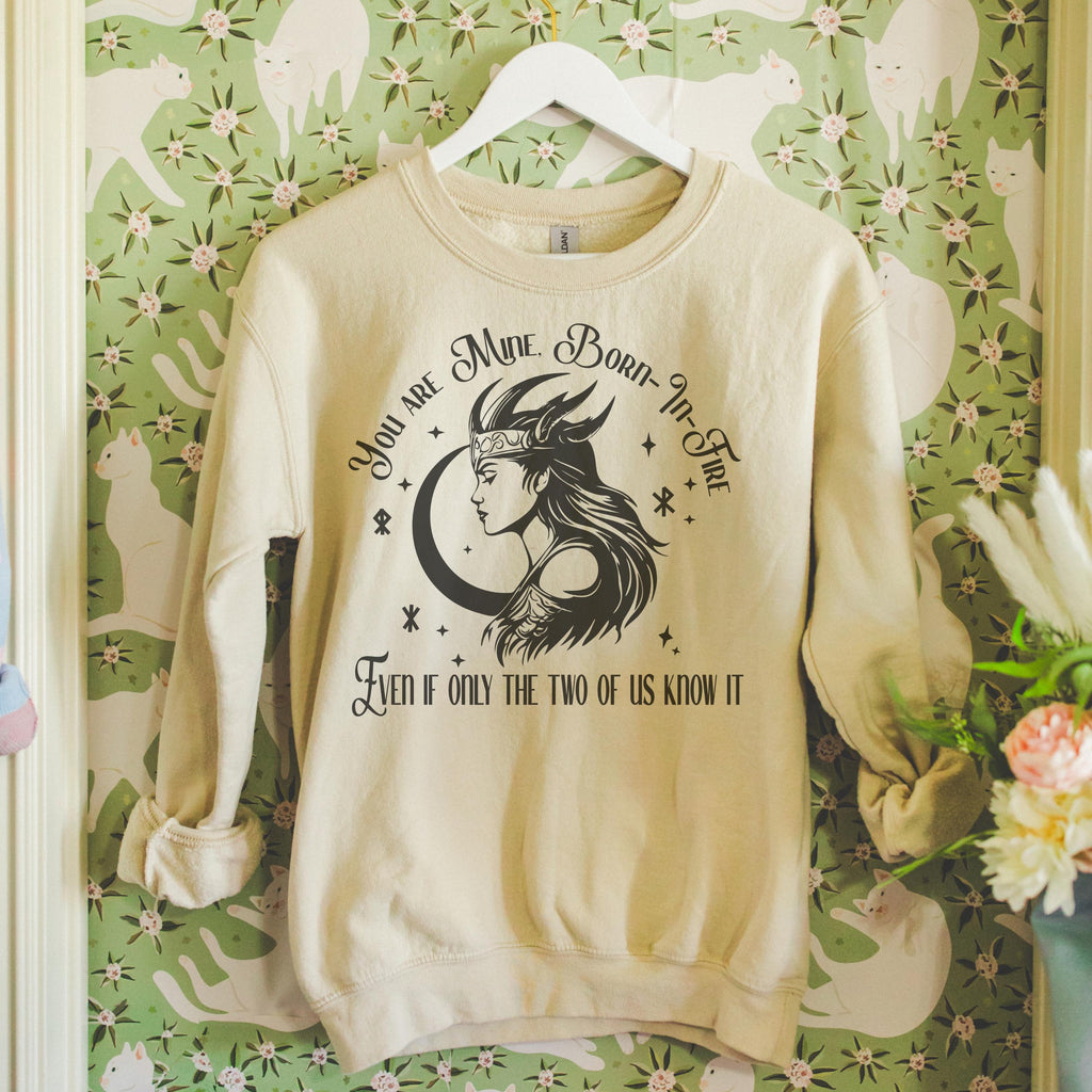 Close-up of soft sweatshirt showing faded graphic and cozy fabric texture.