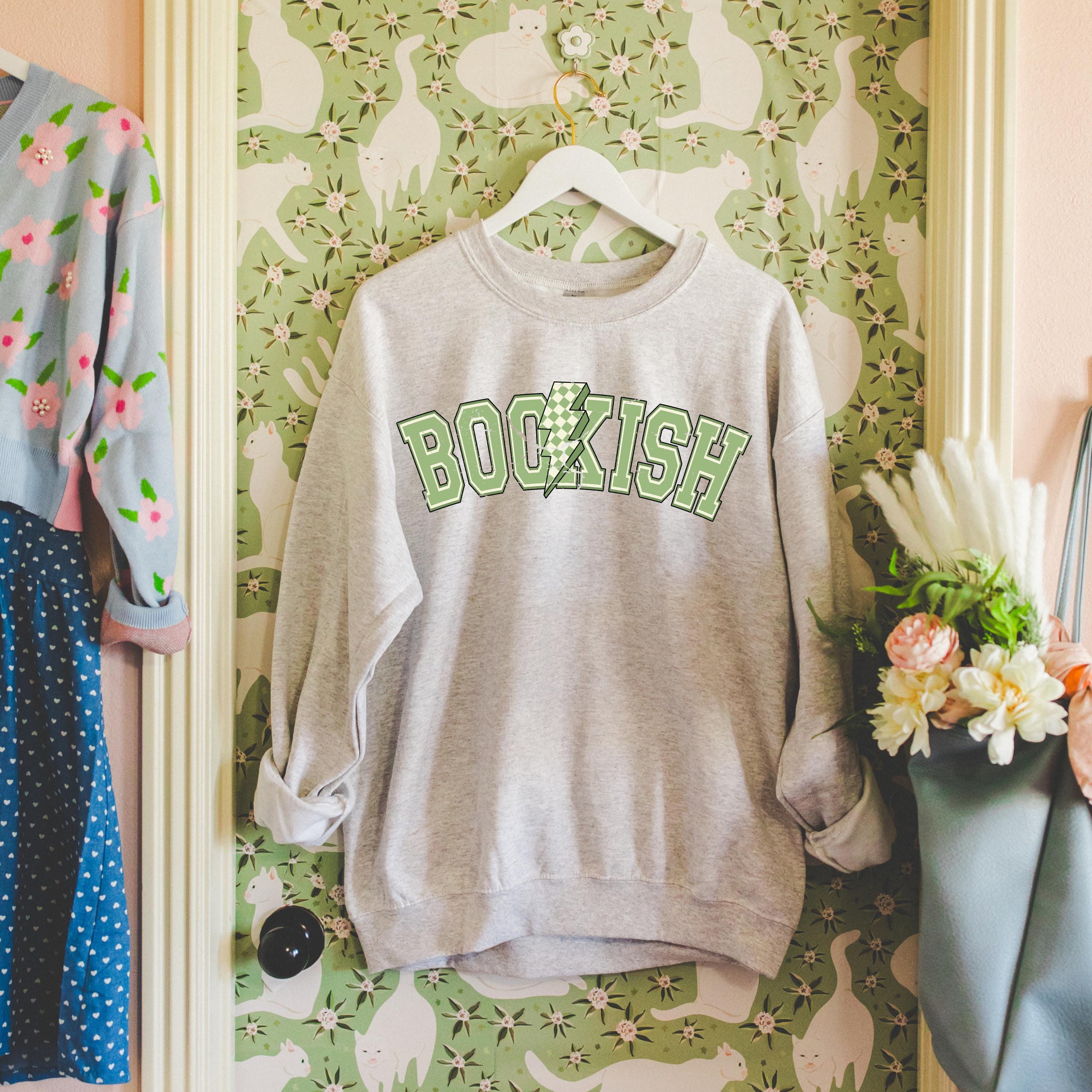 Bookish Bolt sweatshirt styled for a cozy reading moment.