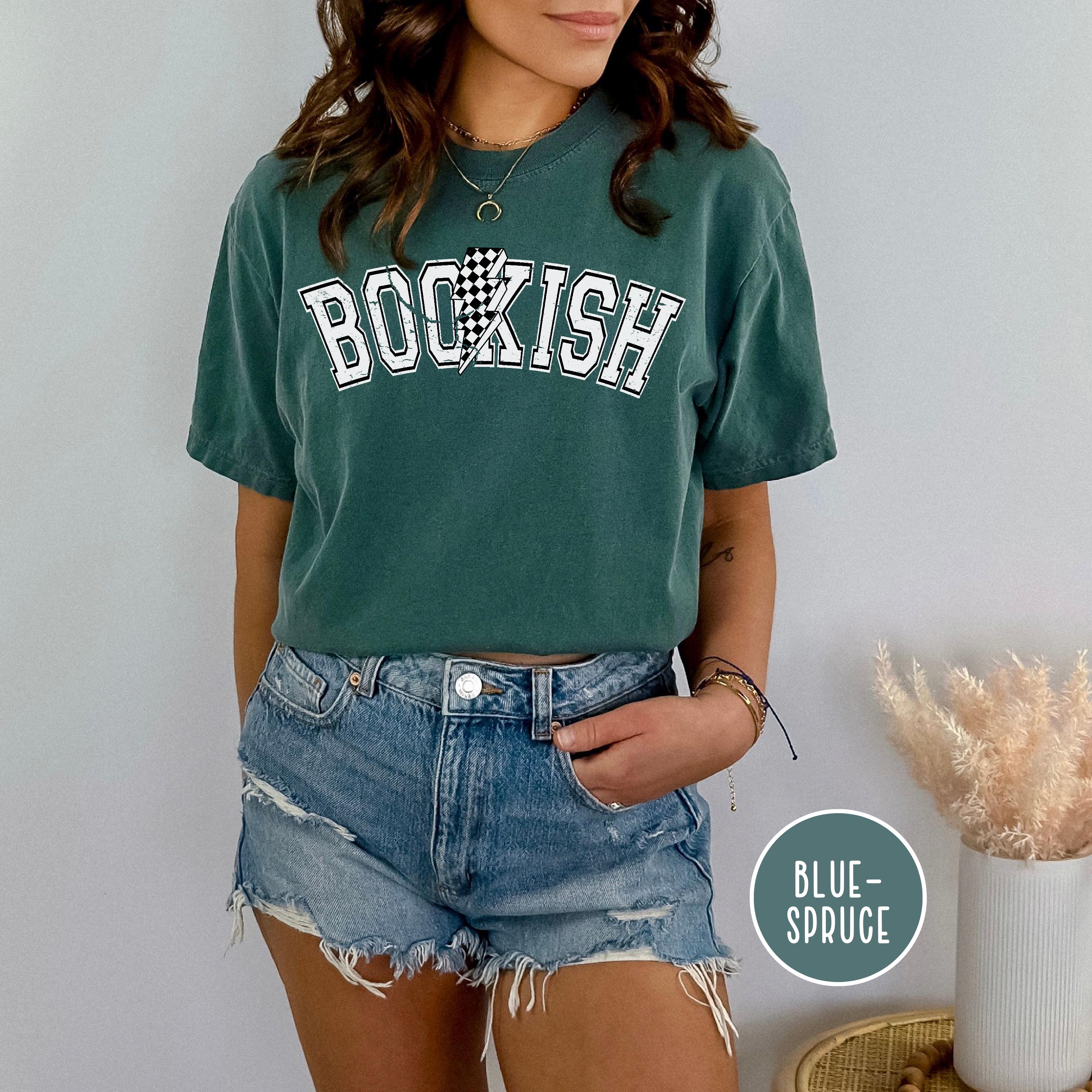 Close-up of vintage collegiate font and checkered lightning bolt design worn by a model.