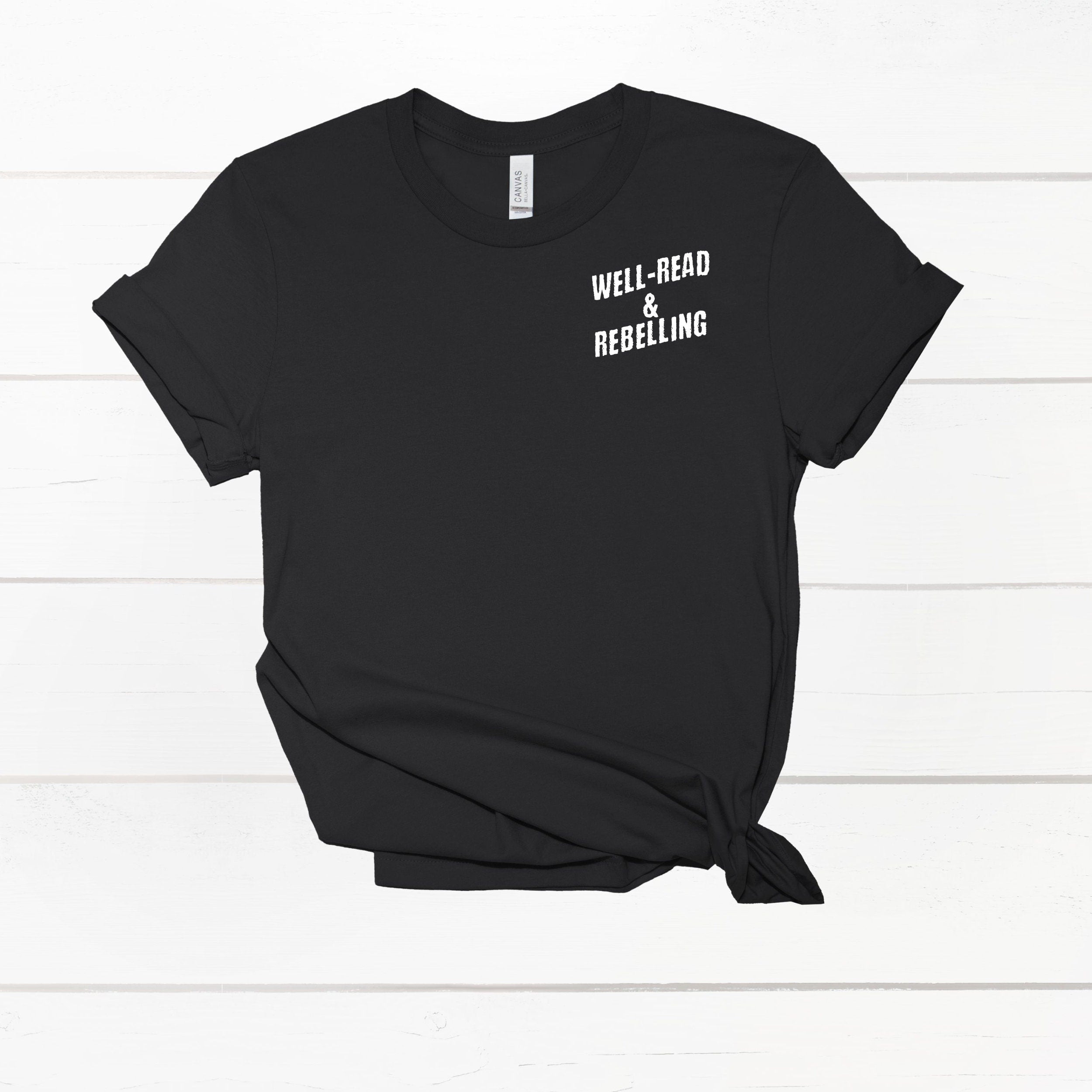 Front view of the Bookish World Tour Tee by Dex Avenue, featuring white 'Well-Read & Rebelling' text on a black cotton t-shirt.